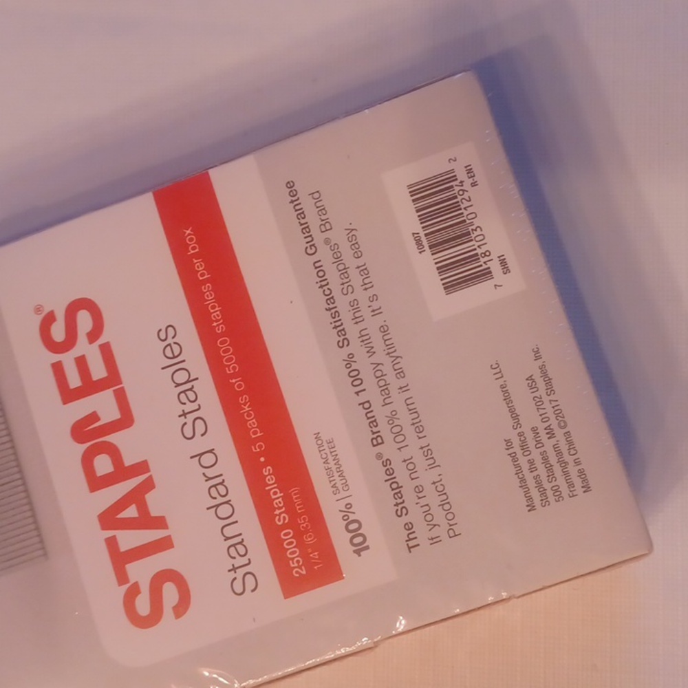 Five unopened boxes of staples.